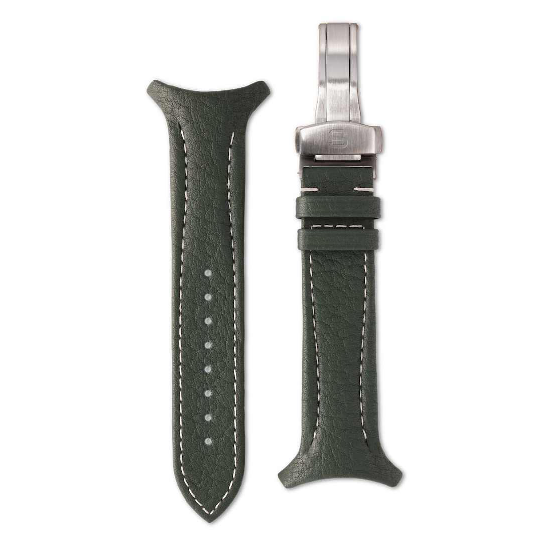Green leather watch strap with silver clasp on a white background