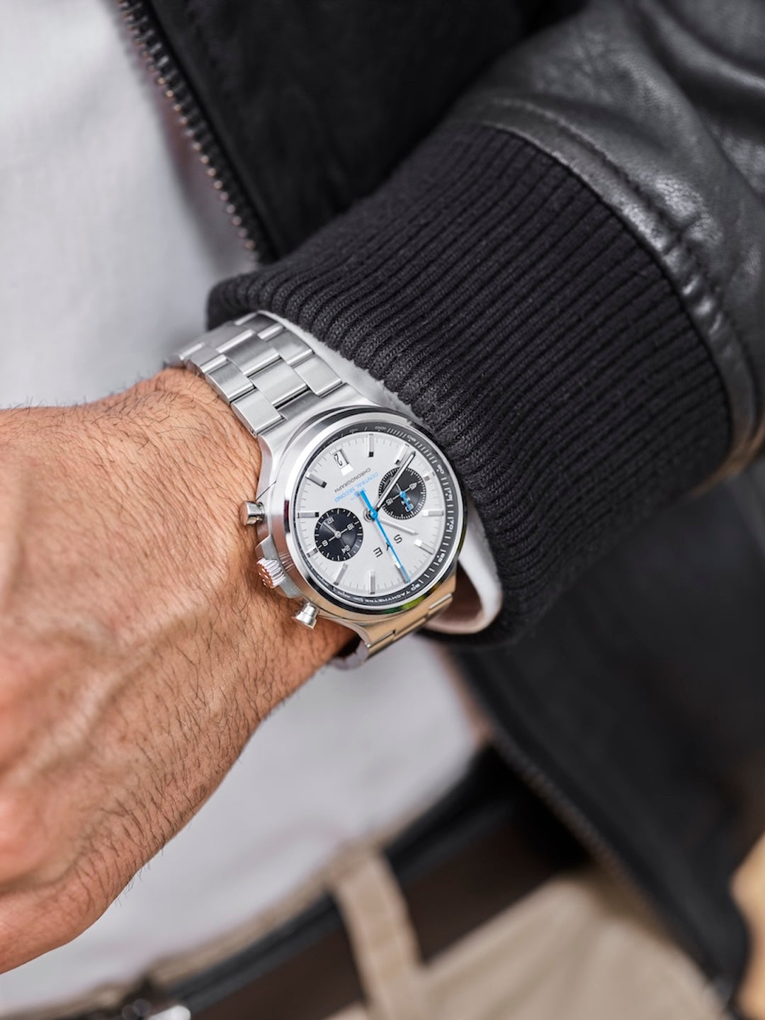 Silver watch on a wrist with a blurred background