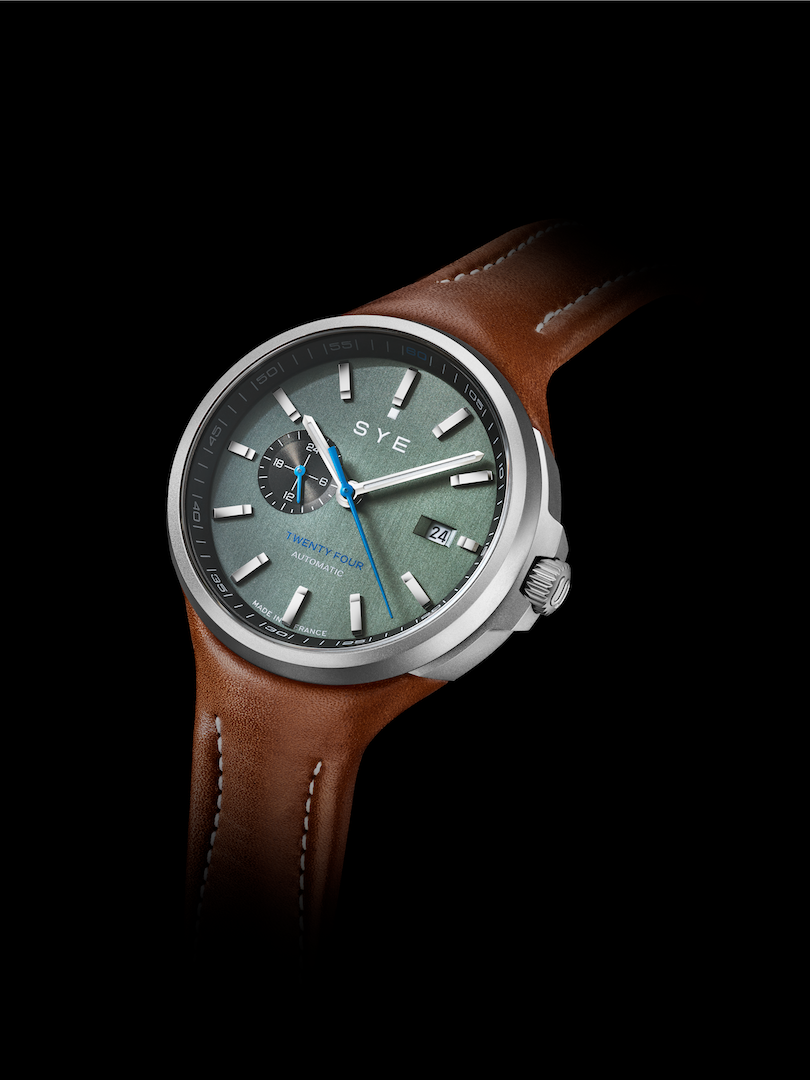 Watch with brown leather strap and gray dial on a black background