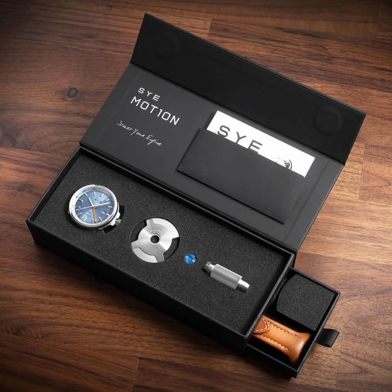 SYE MOTION watch components in a black box on a wooden surface