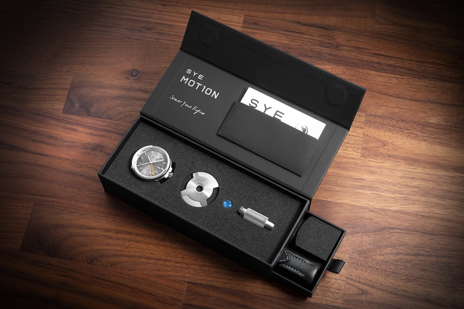 S.Y.E Motion watch set in a black box on a wooden surface