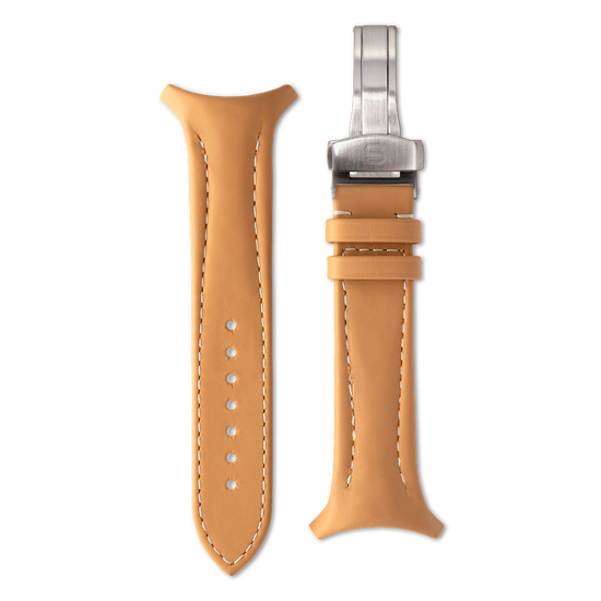 Tan leather watch strap with silver clasp on a white background