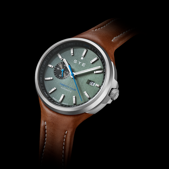 Watch with brown leather strap and gray dial on a black background