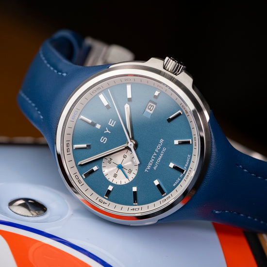Watch with blue strap and blue face on a blurred background