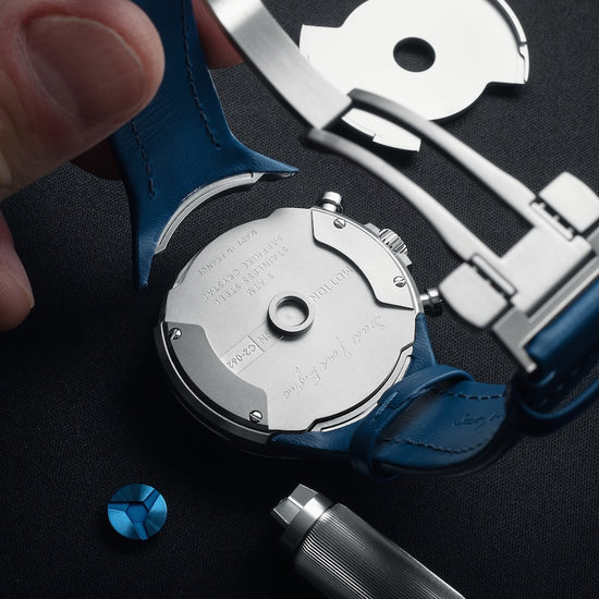 Watch mechanism and tools on a dark surface