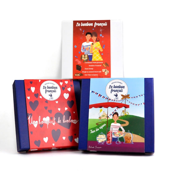 Three different boxes of French candies, each with a colorful and thematic design, part of the 'Trio of boxes' product.